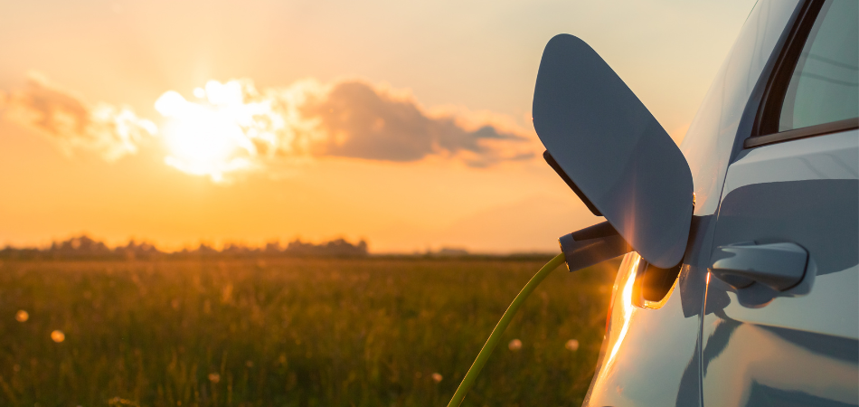 Car getting charged up during sunset