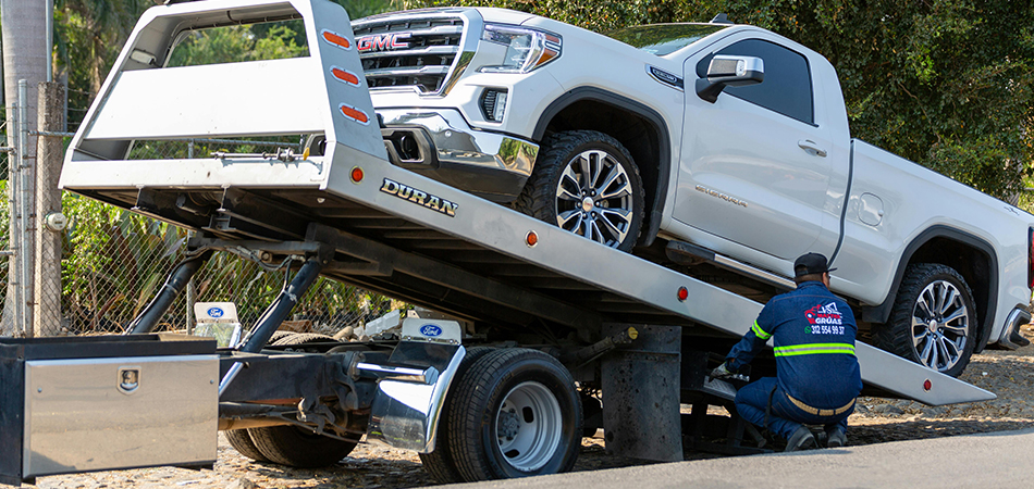 Tower wheeling a vehicle onto the truck