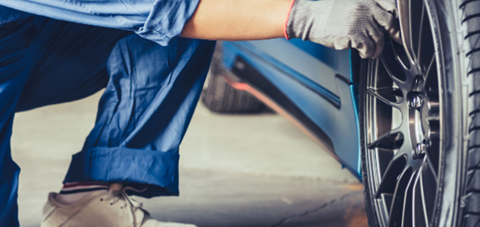 A mechanic checking on the air pressure of a car