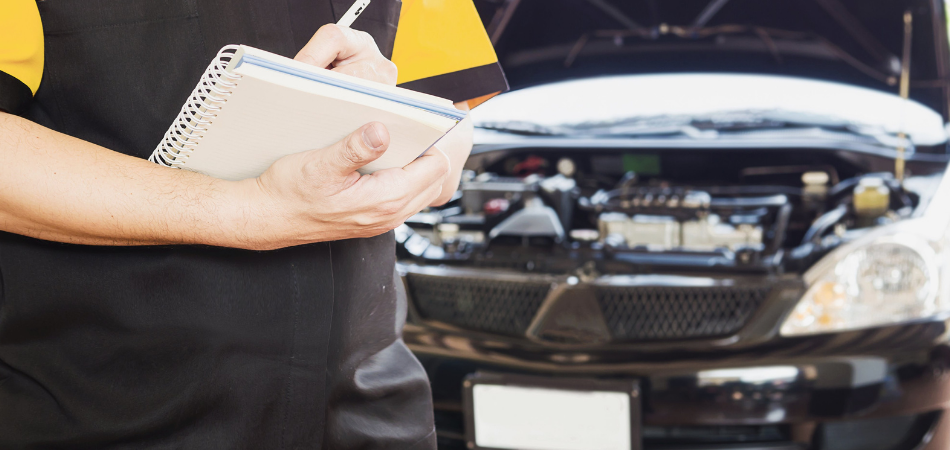 A mechanic writing up a car repair bill