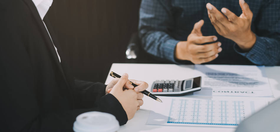 2 guys sitting at the table about vehicle donation process